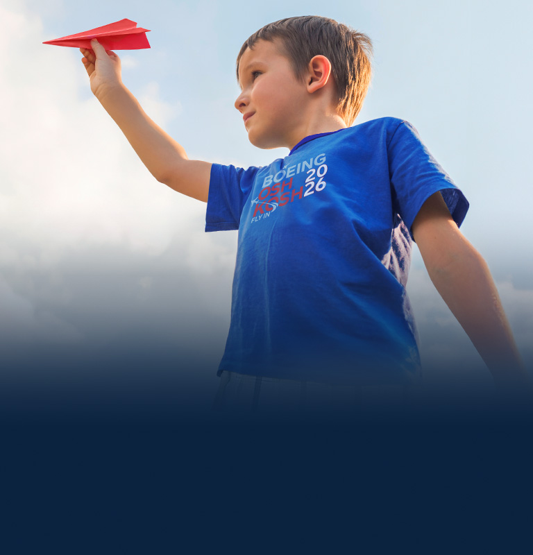 Child playing with paper airplane