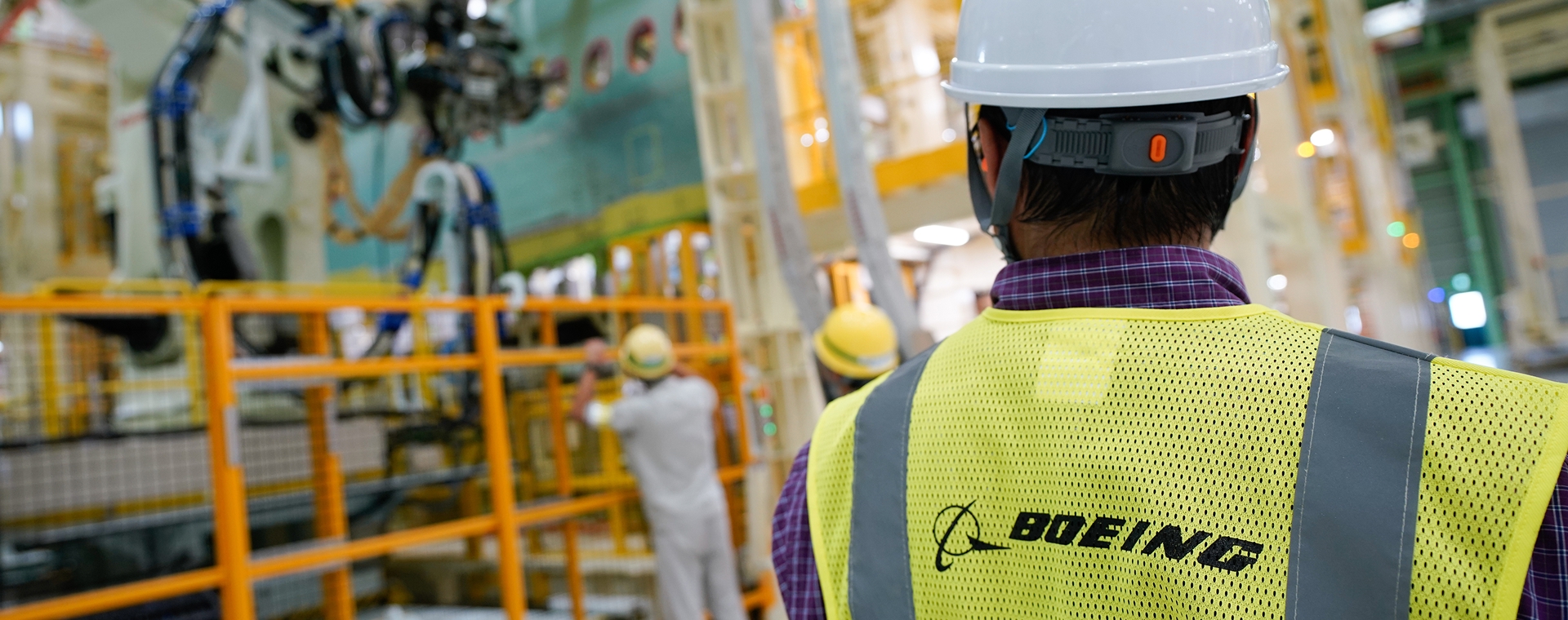 Employee observing other employees working in a Boeing factory