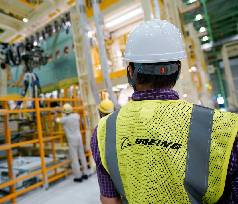 Employee observing other employees working in a Boeing factory