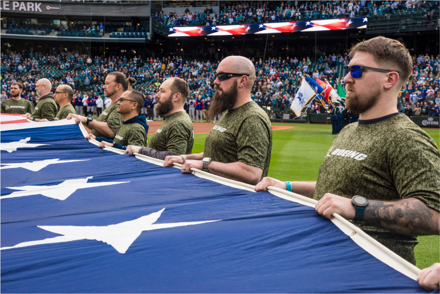 Veteran Boeing employees present the flag during the National Anthem at the Mariners’ 2025 Salute to Armed Forces Night.