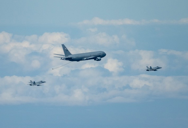 Spanish Air Force EF-18 Hornet approaches a U.S. Air Force KC-46A Pegasus