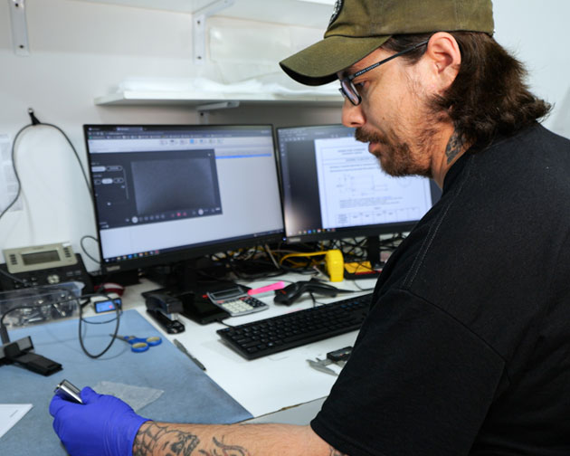 Quality inspector Jereamy Hewett examines a KC-46A bushing. Bushings allow rotating parts to move without the need for lubrication.