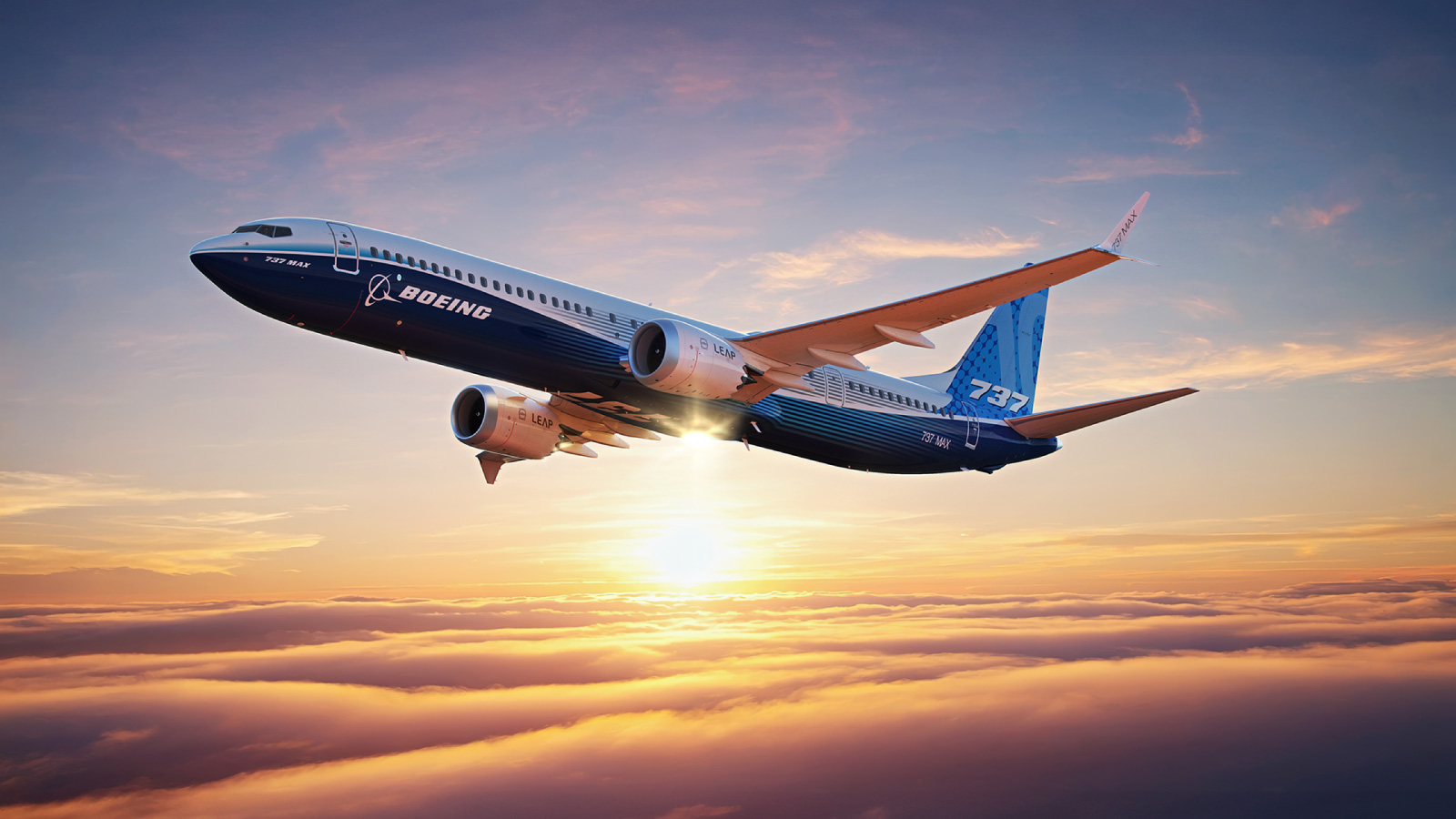 A Boeing 737-10 airplane flies above the clouds.