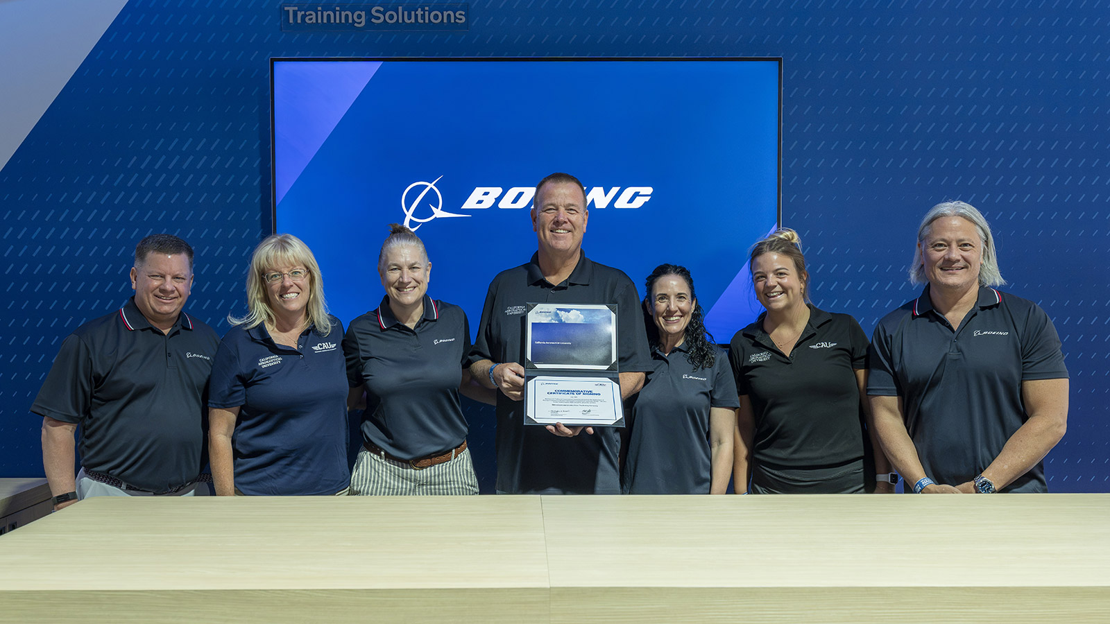 Boeing teammates and California Aeronautical University representatives sign the first deployment of the CBTA Learning Library.