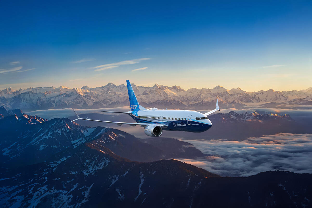 737-7 Boeing Livery airplane flying over snowy mountain background