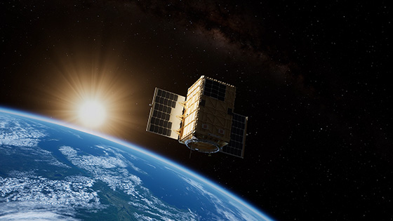 A satellite orbiting Earth with the sun rising in the background, showcasing solar panels.