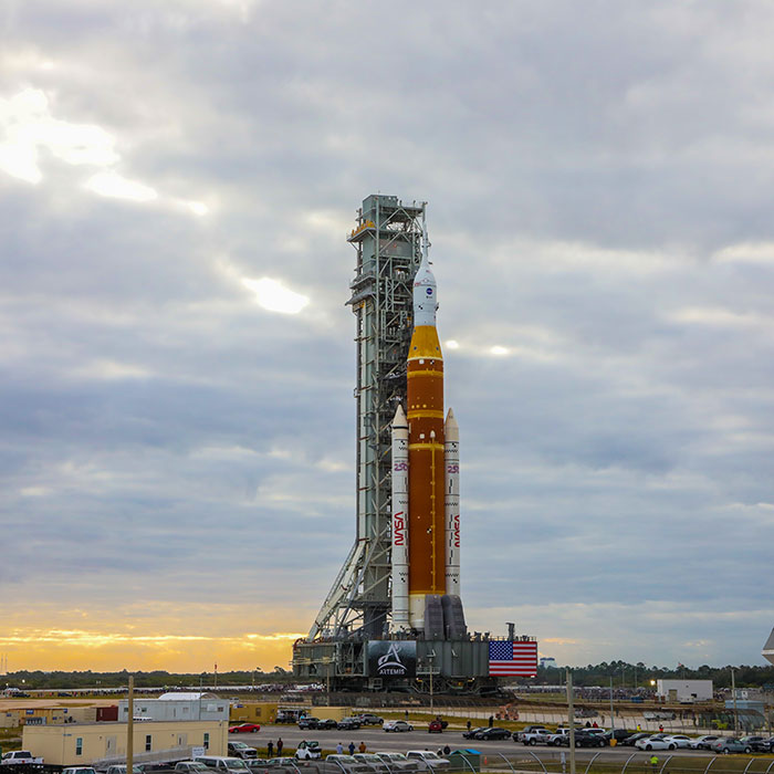 The Artemis II Space Launch System Rocket topped with the Orion spacecraft rolling out of the Vehicle Assembly Building at NASA’s Kennedy Space Center in Florida.